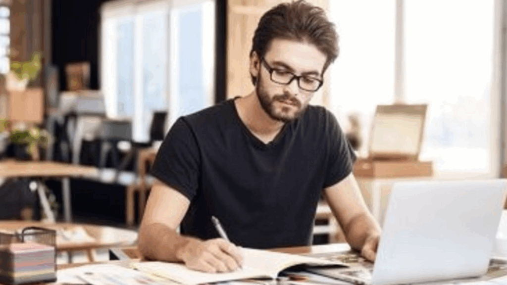 How to Write a Screenplay. A young writer sits at a desk with his laptop. 